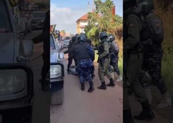 UGANDA POLICE MEN  KICK BOBI WINE SUPPORTER LIKE A BALL